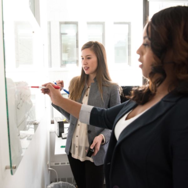 women writing on board