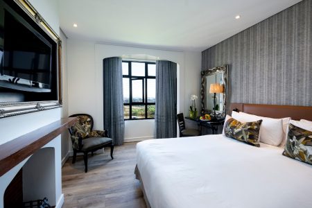 Hotel with bed, tv and dressing table