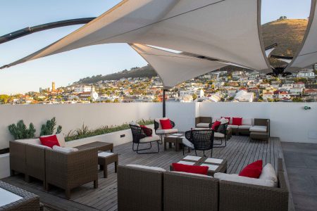 Hotel terrace with lounge area and a view of cape town