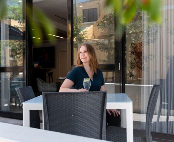 Young lady enjoying a glass of water at a restaurant